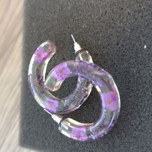 Maurices clear earrings with purple flowers inside.